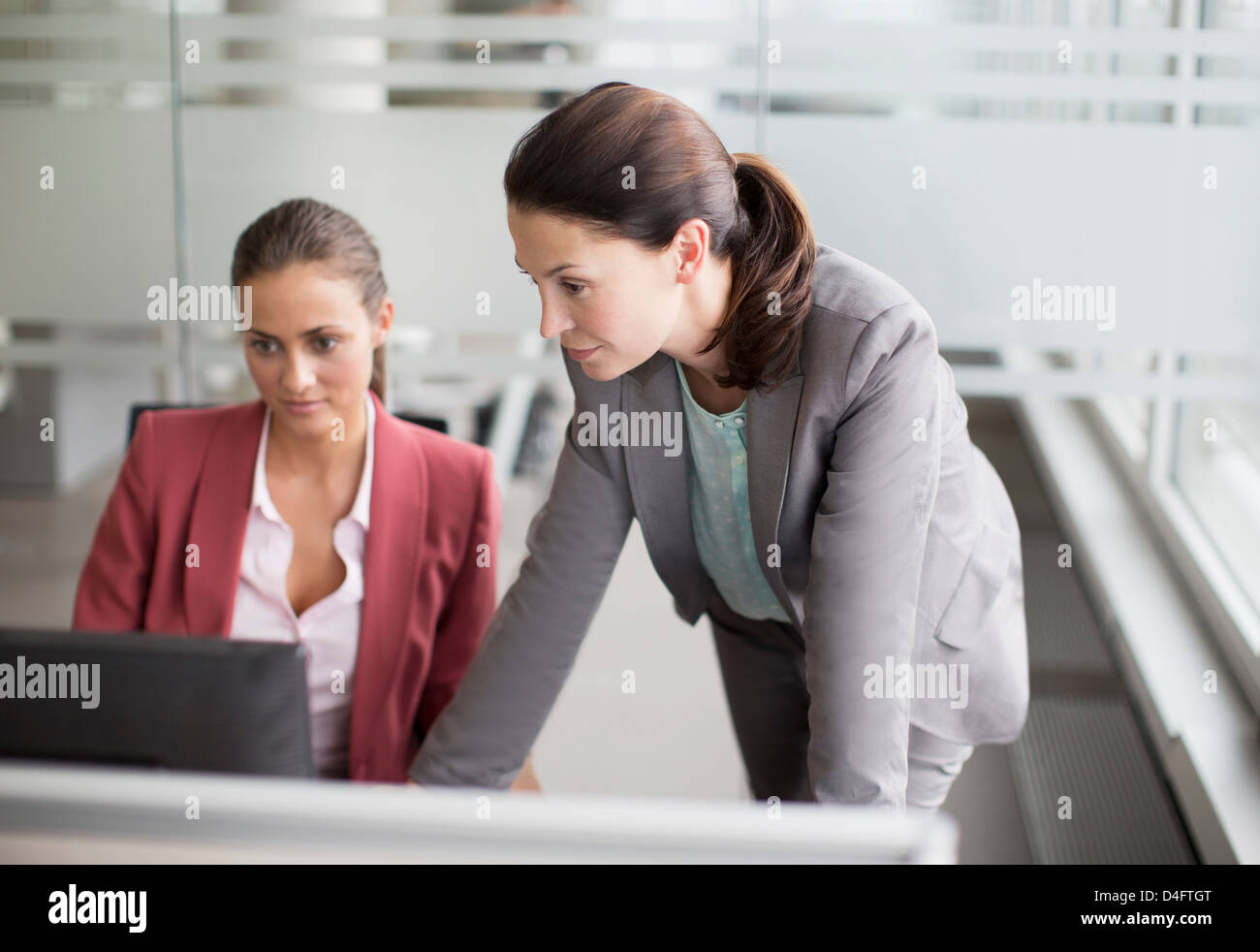 Businesswomen working together at desk Stock Photo - Alamy