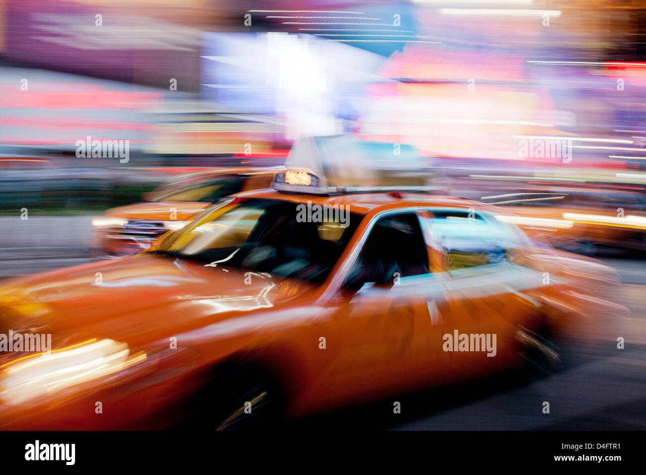 Blurred view of taxi on city street at night Stock Photo