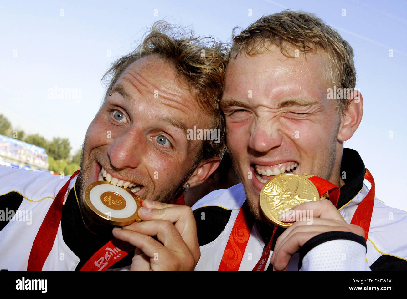 Andreas Ihle (L) and Martin Hollstein of Germany both bite their Gold Medals during the medal ceremony for the Kayak Double (K2) 1000m Men Final at Shunyi Olympic Rowing-Canoeing Park at the 2008 Beijing Olympic Games, Beijing, China, 22 August 2008. Photo: Jens Buettner ###dpa### Stock Photo