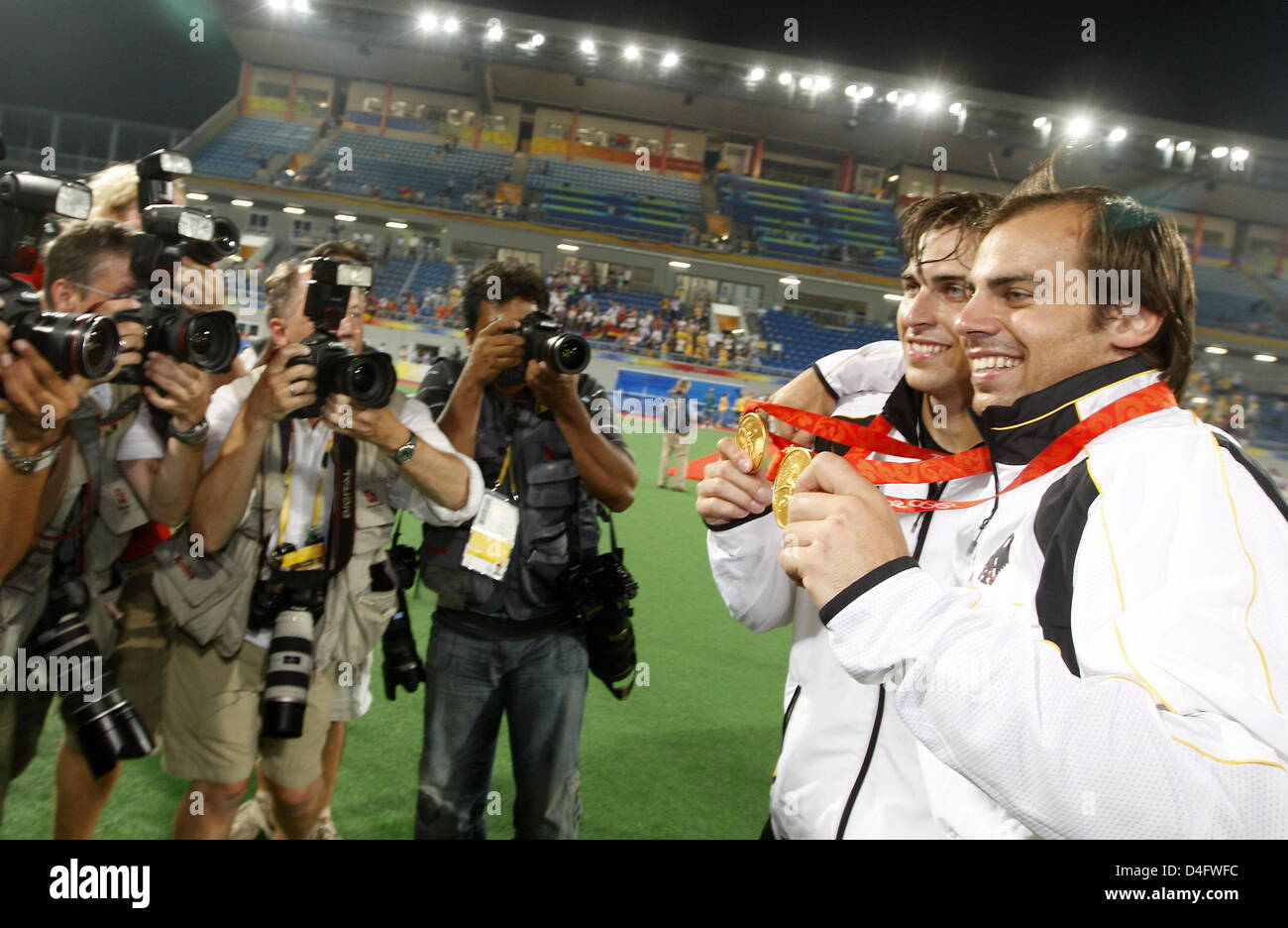 Philipp Zeller (R) and Christopher Zeller (2nd R) of Germany show their