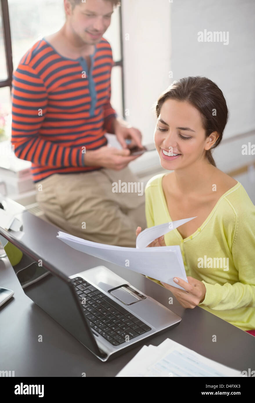 Couple working together at desk Stock Photo