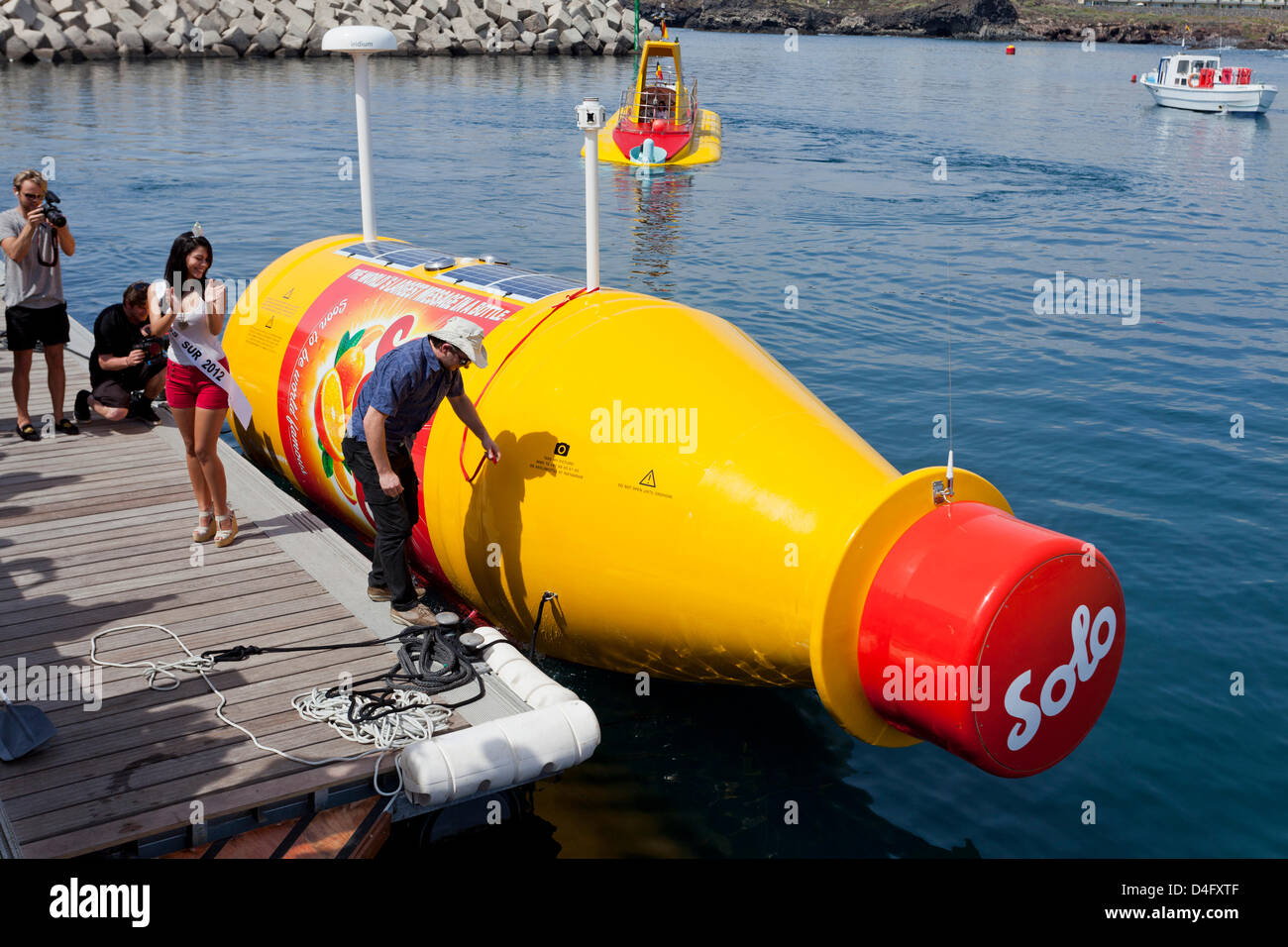 Tenerife. 13th March 2013. Jarle Andhoy and Sady Chavez, Miss Tenerife Sur at The official launch of world's biggest message in a bottle took place at San Miguel Marina. The launch ceremony conducted by Miss Tenerife Sur, Sady Chavez, and the Norwegian polar explorer Jarle Andhoy who ceremoniously broke a bottle of Solo soda pop to mark the occasion. The bottlre will be towed out to sea and set adrift and whoever finds it as it comes ashore will be rewarded with a prize from the Solo soft drinks company. Credit:  Phil Crean A / Alamy Live News Stock Photo