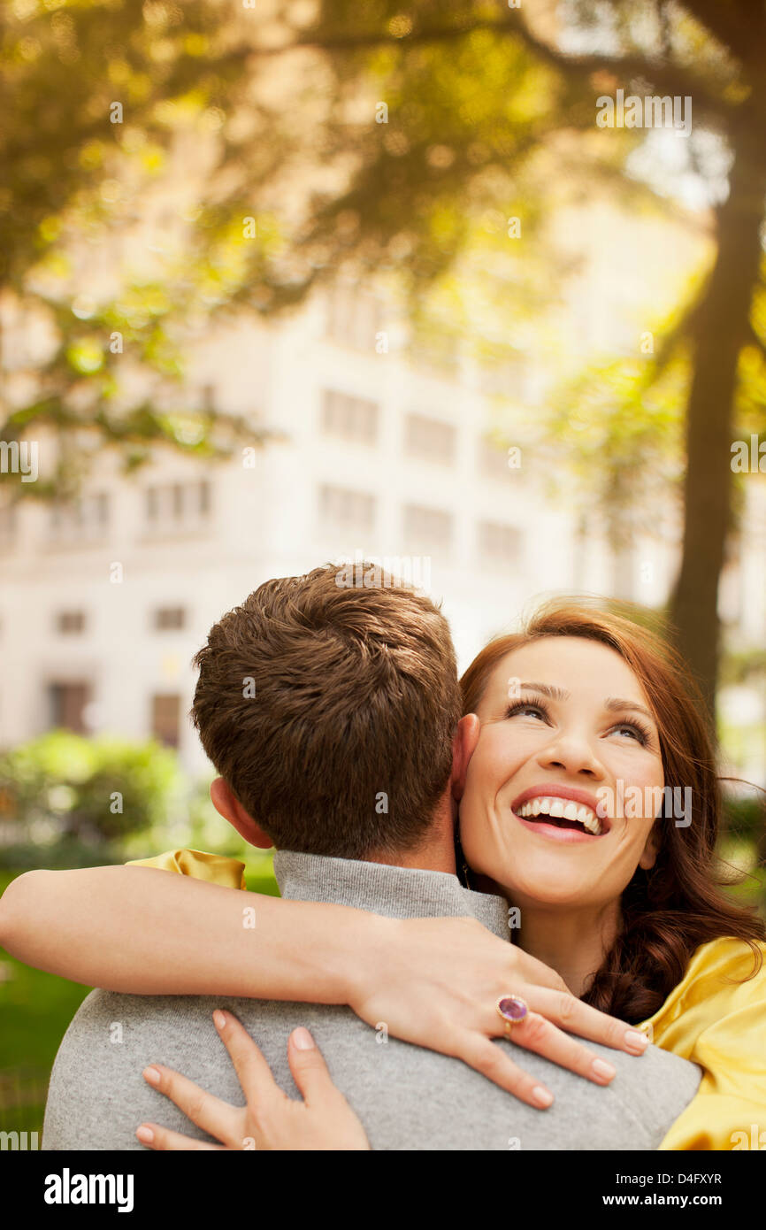 Couple hugging in urban park Stock Photo - Alamy