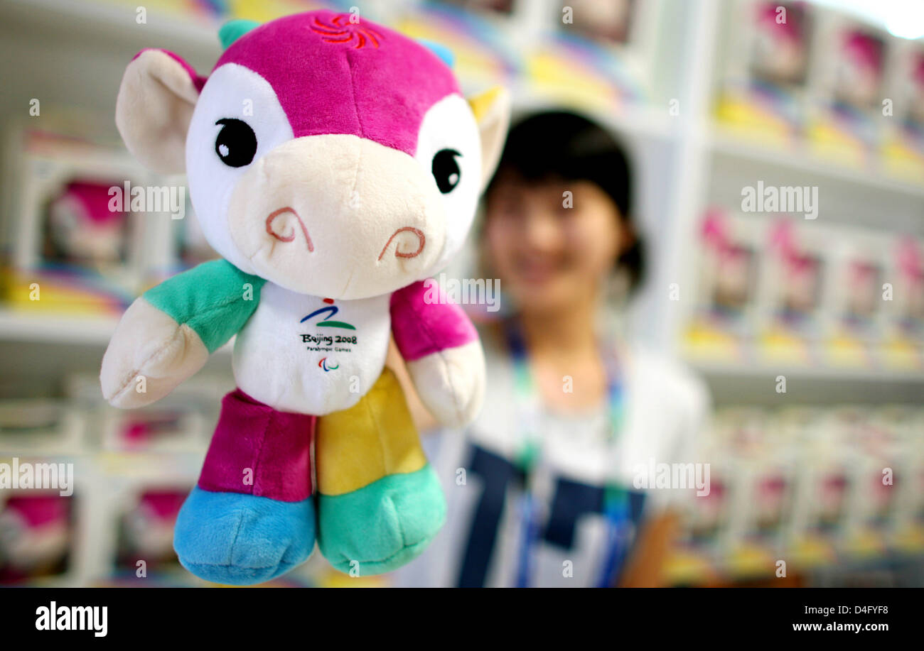 A shop employee presents the mascot of the Paralympic Games, Fu Niu Lele, in Beijing, China, 04 September 2008. The Paralympics will be launched on 06 September. Photo: Rolf Vennenbernd Stock Photo