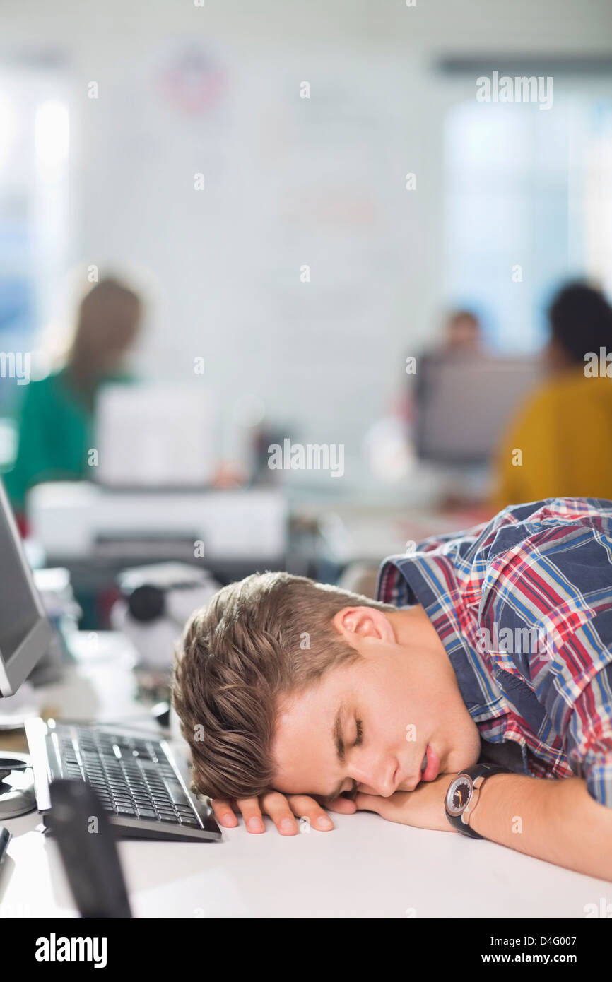 Businessman sleeping at desk Stock Photo
