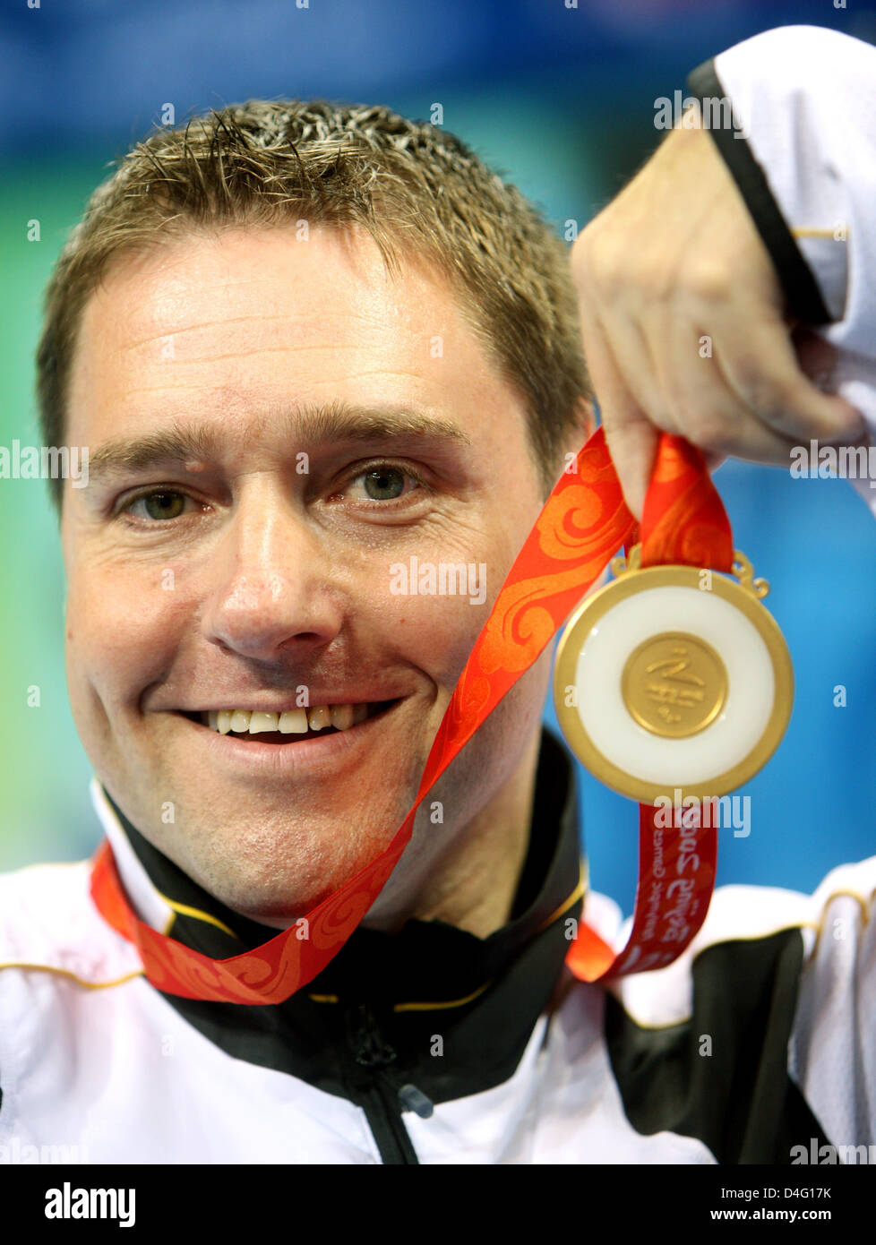 German table tennis player Jochen Wollmert presents his gold medal at