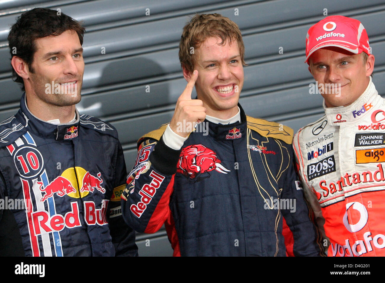 German Formula One driver Sebastian Vettel, pole setter of Scuderia Toro  Rosso-Ferrari (C), poses with second-positioned Heikki Kovalainen of  McLaren Merecedes (R) and third-positioned Finn Australian Mark Webber of  Red Bull Racing-Renault (