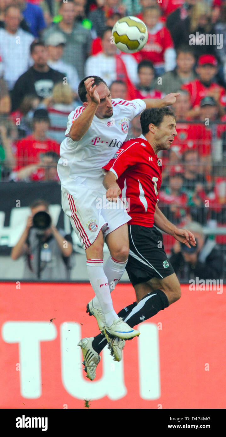 Munich's Franck Ribery (L) and Hanover's Steven Cherundolo (R) vie for ...