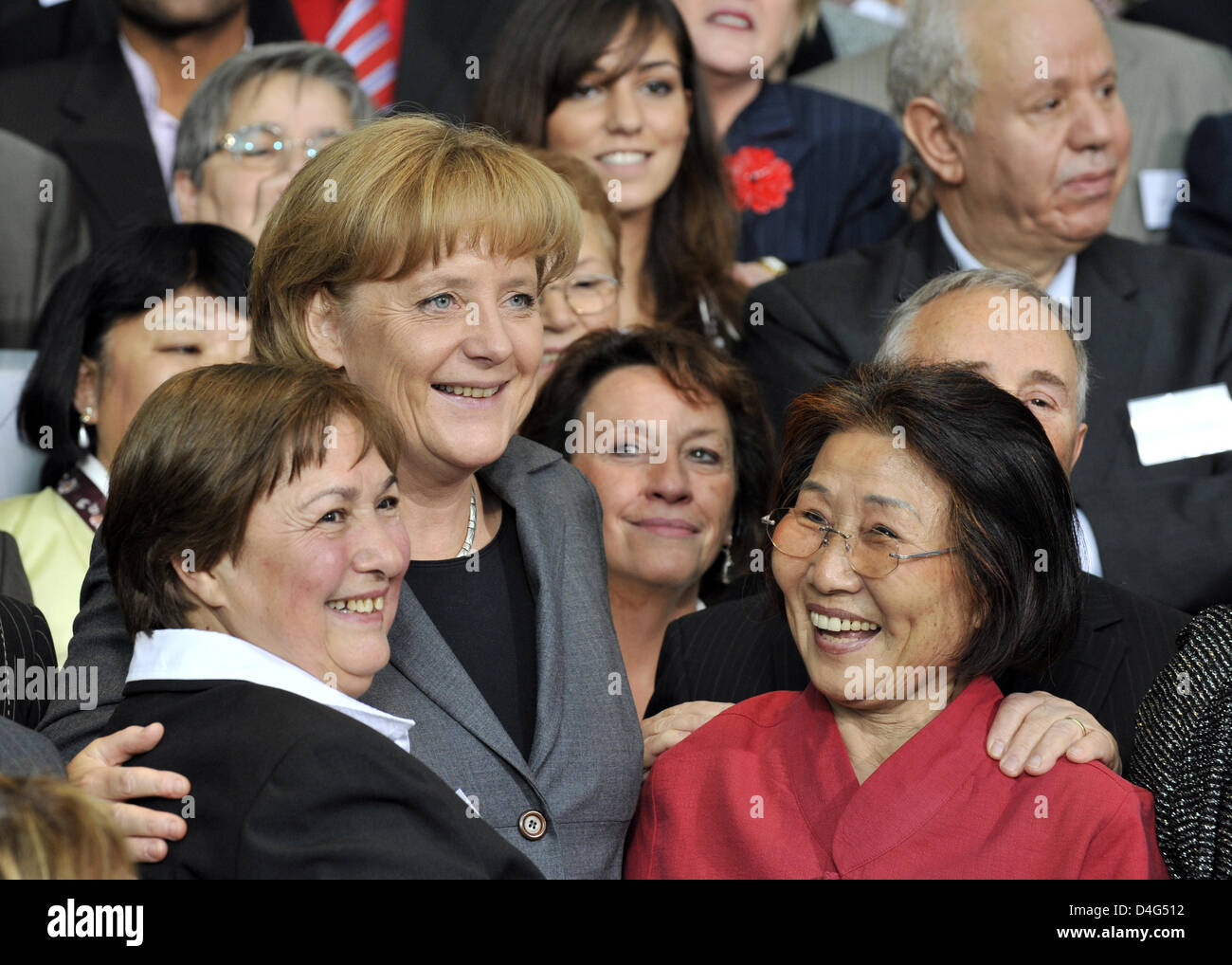 German Chancellor Angela Merkel (2-L) chats with a migrant at the chancellory in Berlin, Germany, 01 Oktober 2008. Merkel honoured the achievements of foreign workers for Germany within the scope of the event 'Germany Says Thank You' ('Deutschland sagt Danke!'). About 200 employees of the first generation of guest- and contract workers were invited to the chancellory. Photo: RAINER Stock Photo