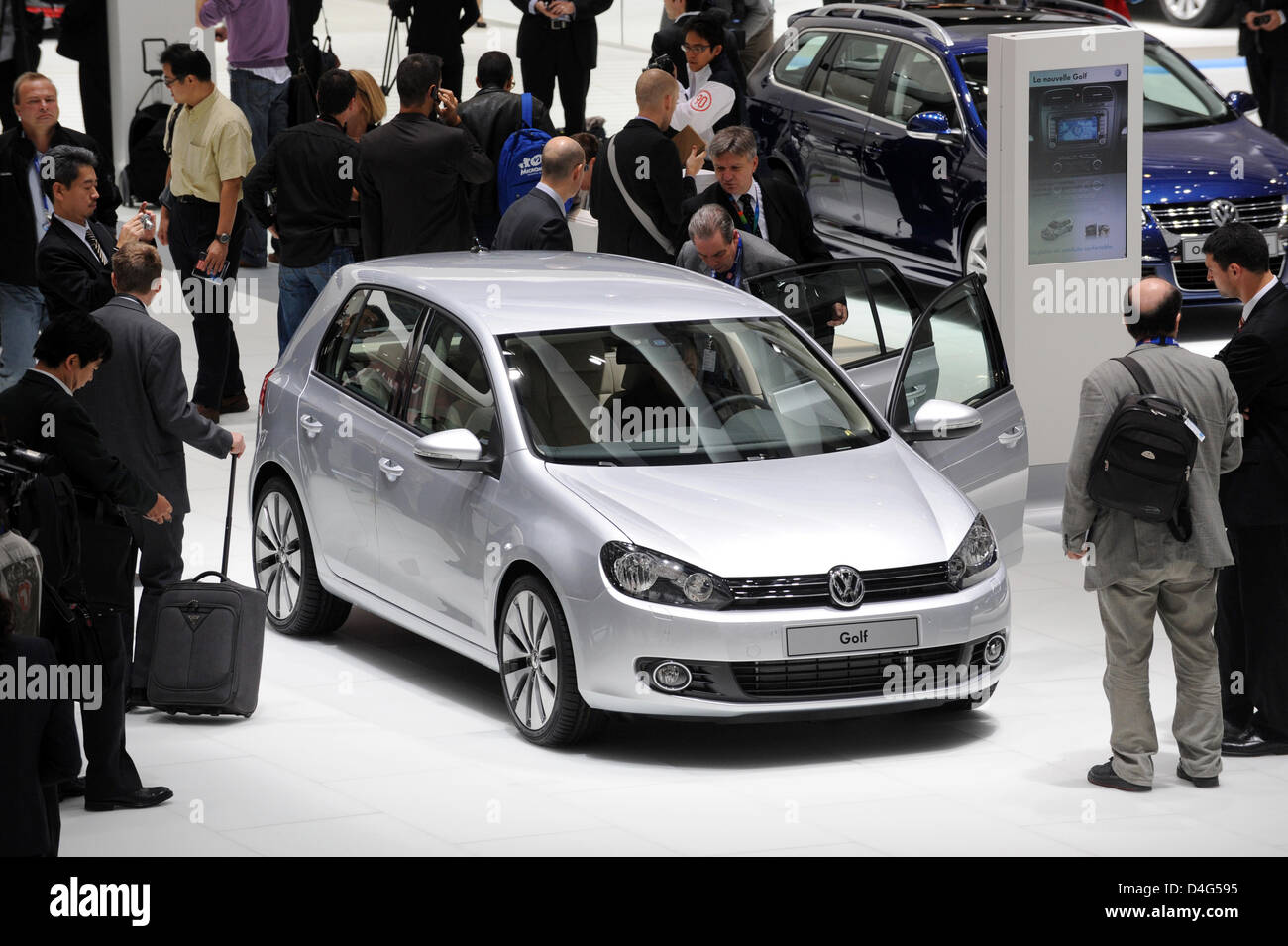 Guests look at the new VW Golf during its presentation ahead of the ...