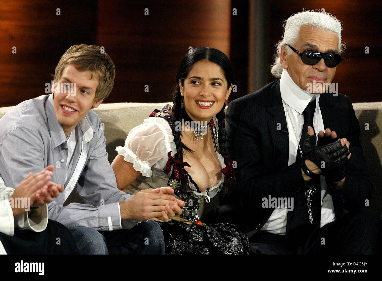 Formula One driver Sebastian Vettel (L-R), actress Salma Hayek and fashion  designer Karl Lagerfeld smile during the famous entertainment show 'Wetten,  dass..?' (Wanna Bet..?) broadcasted by public service channel ZDF in  Nuremberg,