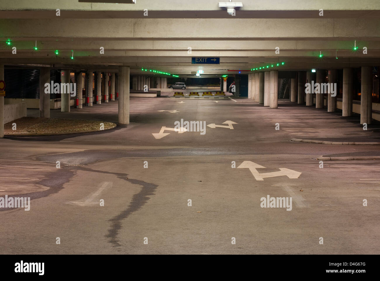 Empty parking garage with little green lights to illuminate the free parking places Stock Photo