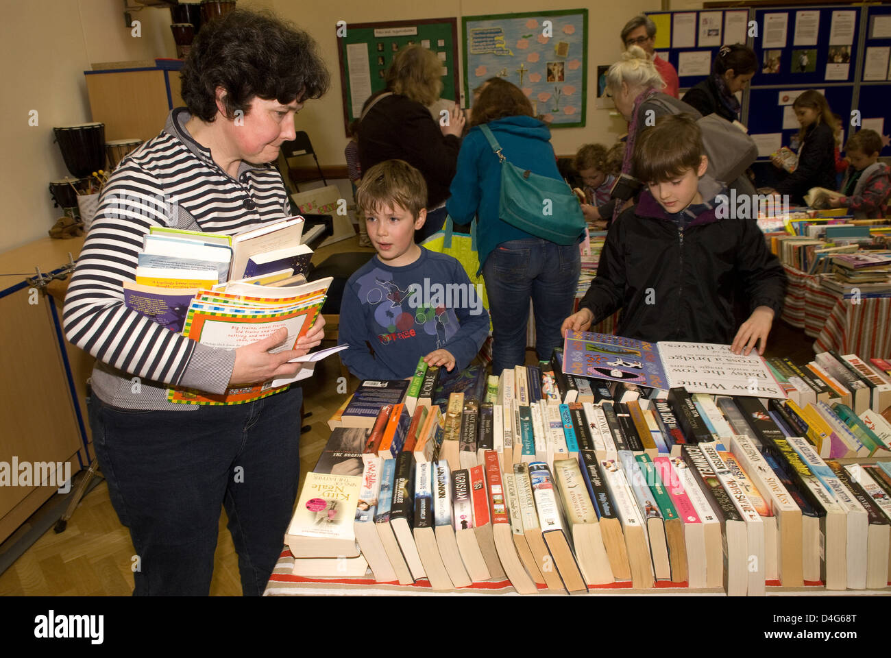 People perusing books at a Charity Book Day in aid of a heart charity ...
