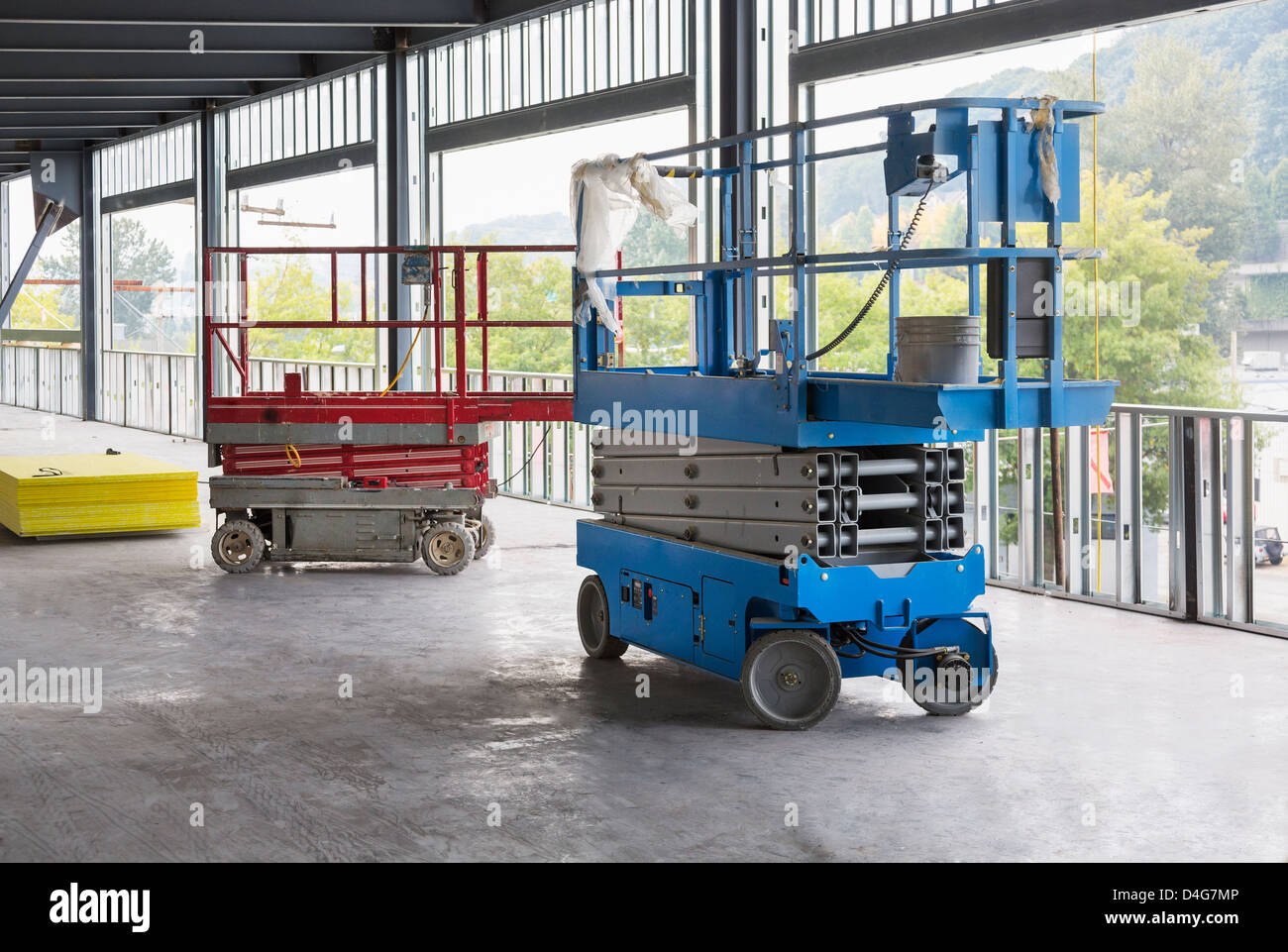 Commercial building. Two cherry pickers, machines with extendable