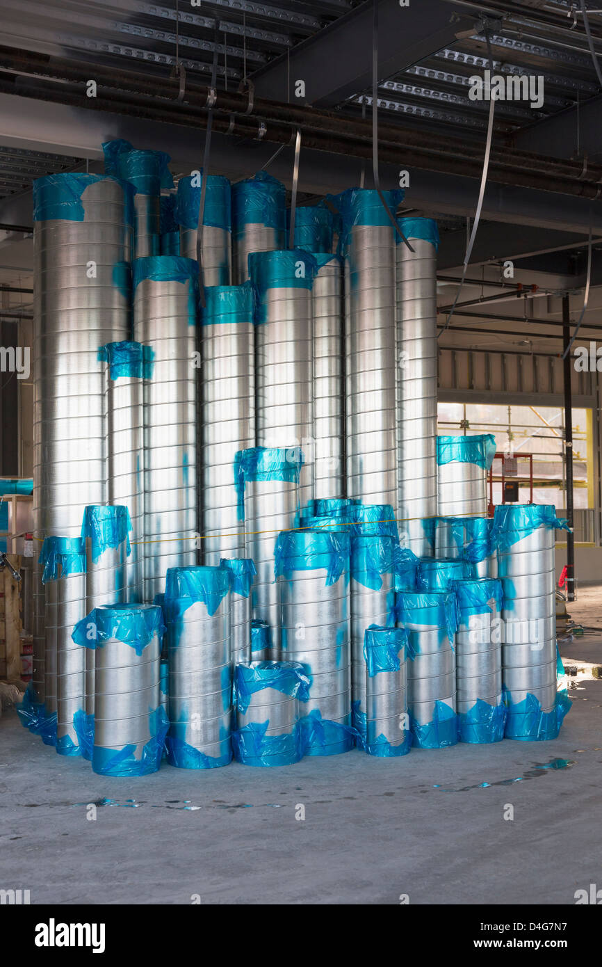 A commercial building under construction. Materials stacked up. Round ...