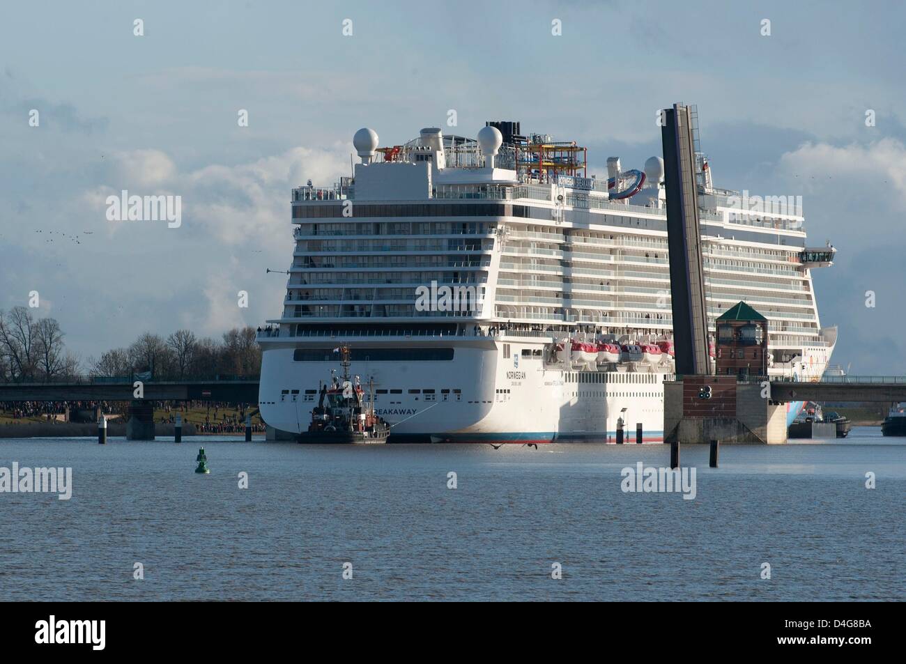 The 'Norwegian Breakaway' passes the Jann Berghaus Bridge during its  transfer to the North Sea via the Ems in Leer, Germany, 13 March 2013. The  324 m long and 40 m wide