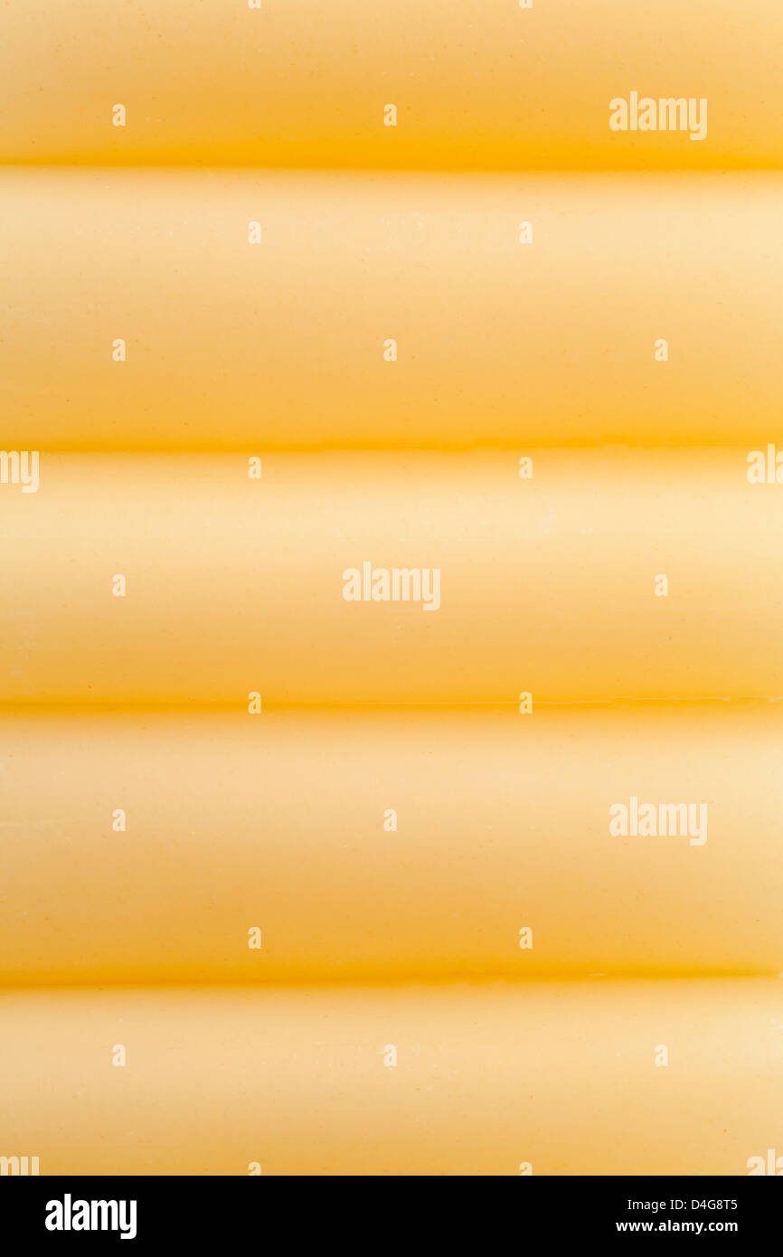 dried cannelloni background or yellow pasta texture Stock Photo