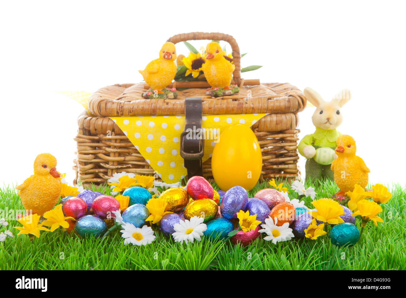 Colorful easter eggs, bunny, chickens and basket on green grass with ...