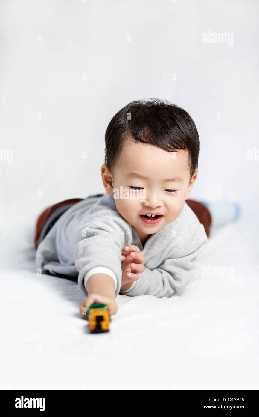 Happy little boy playing toy car Stock Photo - Alamy