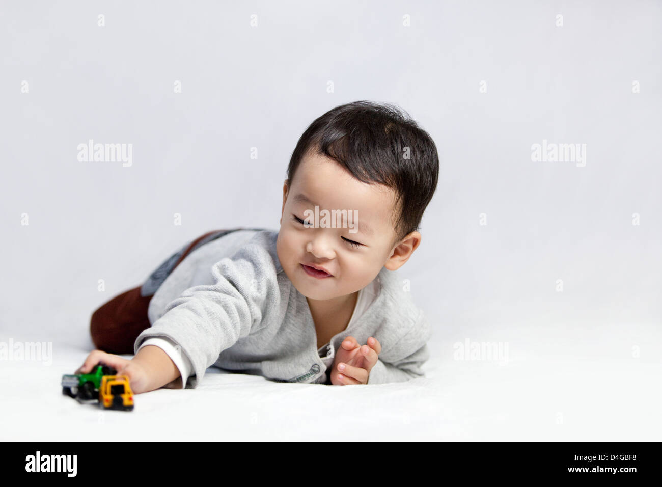 Happy little boy playing toy car Stock Photo - Alamy
