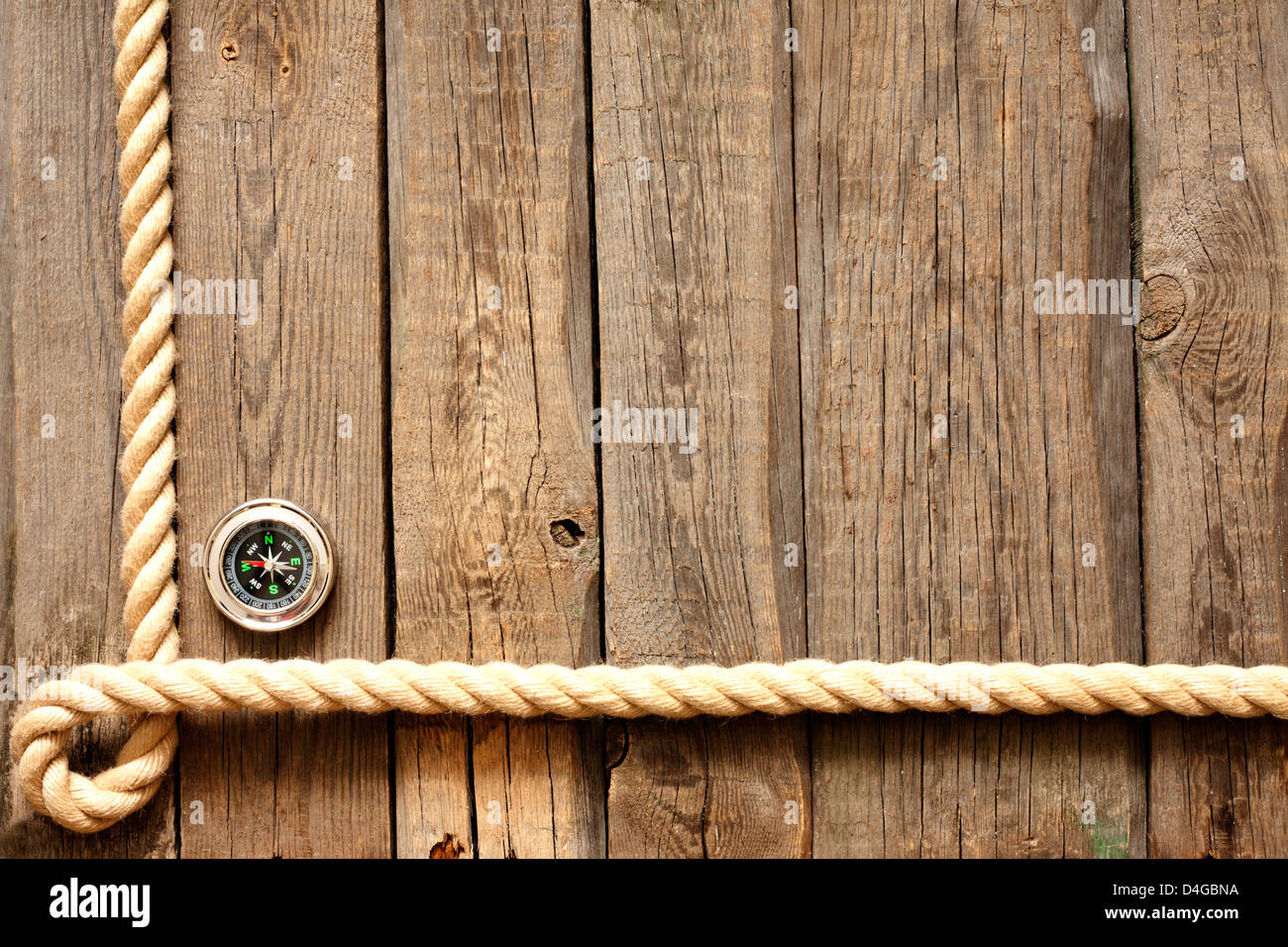 Old wooden planks and rope with compass vintage background Stock Photo