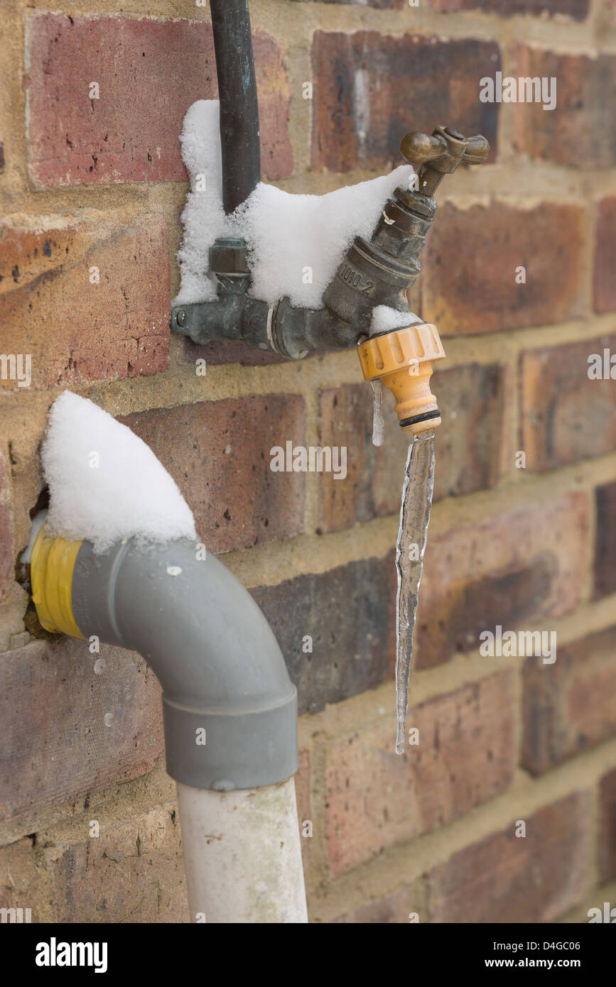 Leaking water tap frozen over in sub zero conditions icicle hanging