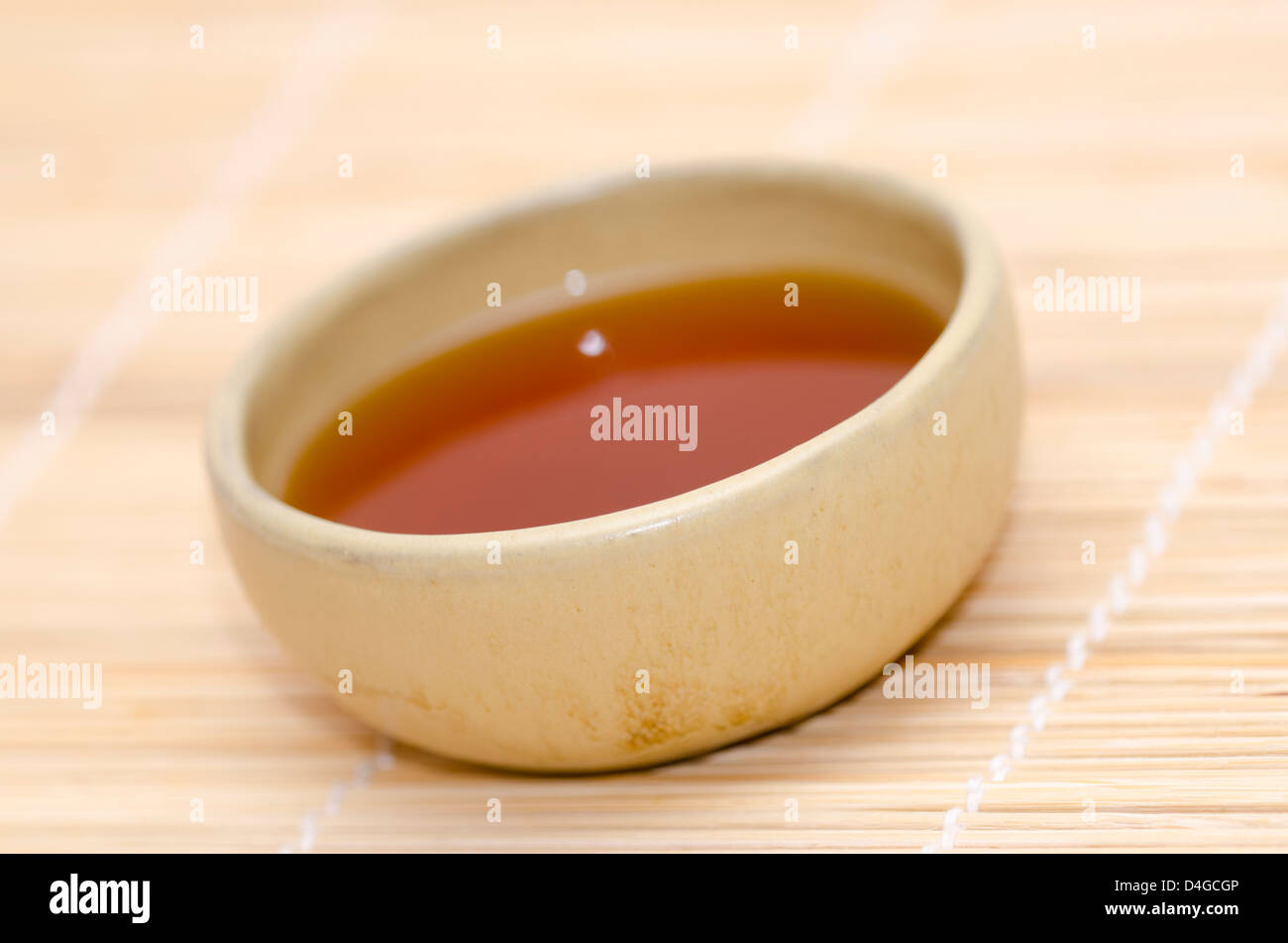 ceramic bowl with indian black tea on wooden stick background Stock Photo