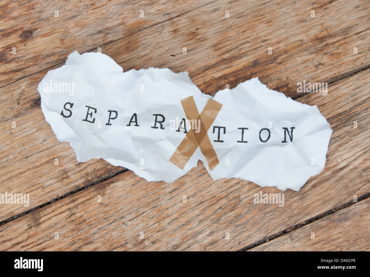 Torn piece of paper with the word taped back together Stock Photo