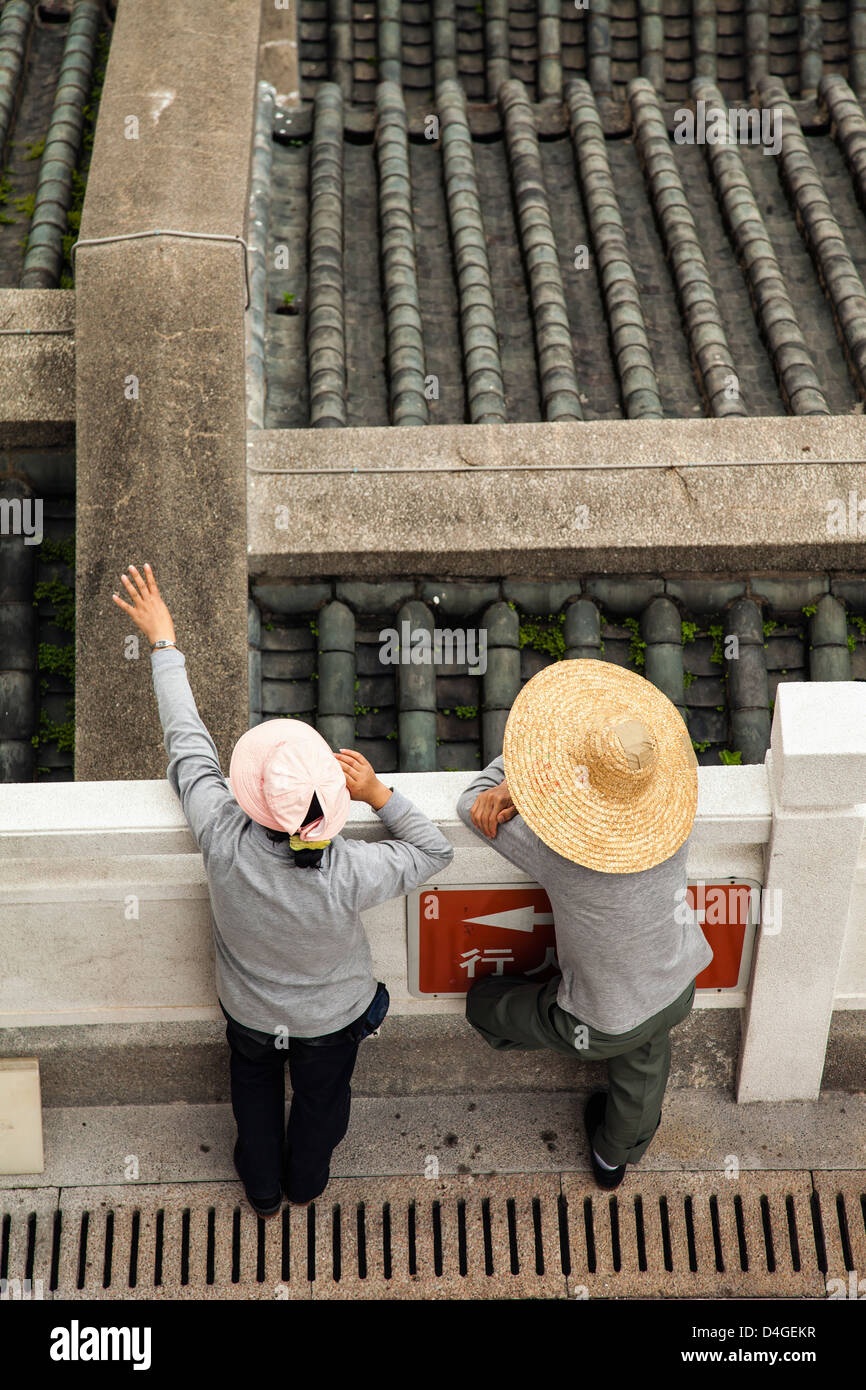 Two workers in a cemetery in Hong Kong. Stock Photo
