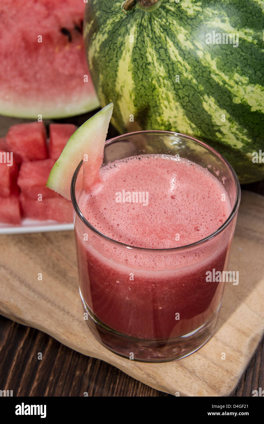 Homemade Watermelon Juice with fresh fruit pieces on wood Stock Photo