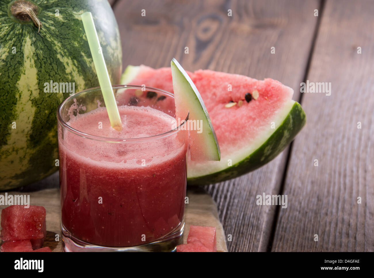 Glass with fresh Watermelon Juice and pieces of fruit Stock Photo