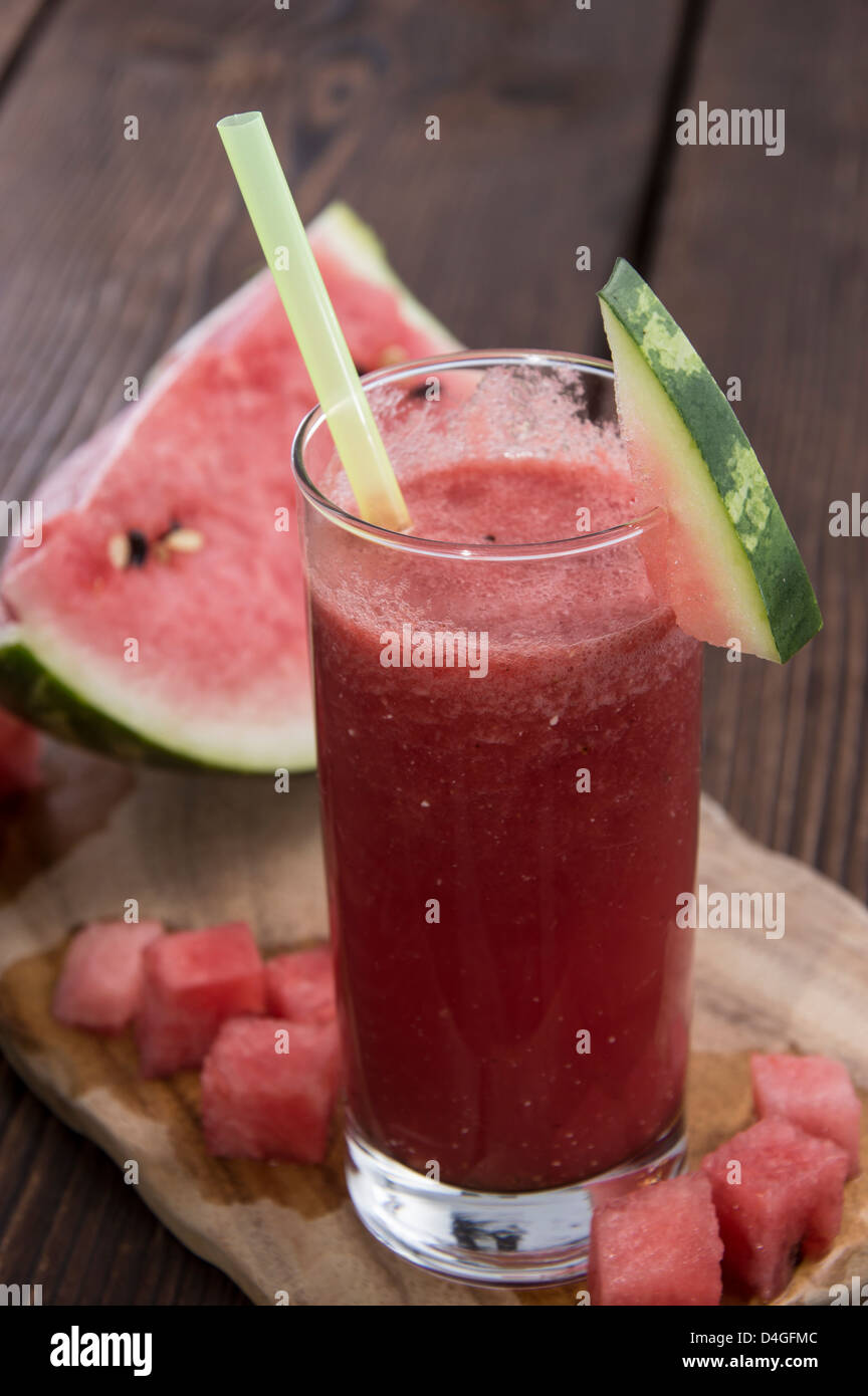 Homemade Watermelon Juice with fresh fruit pieces on wood Stock Photo