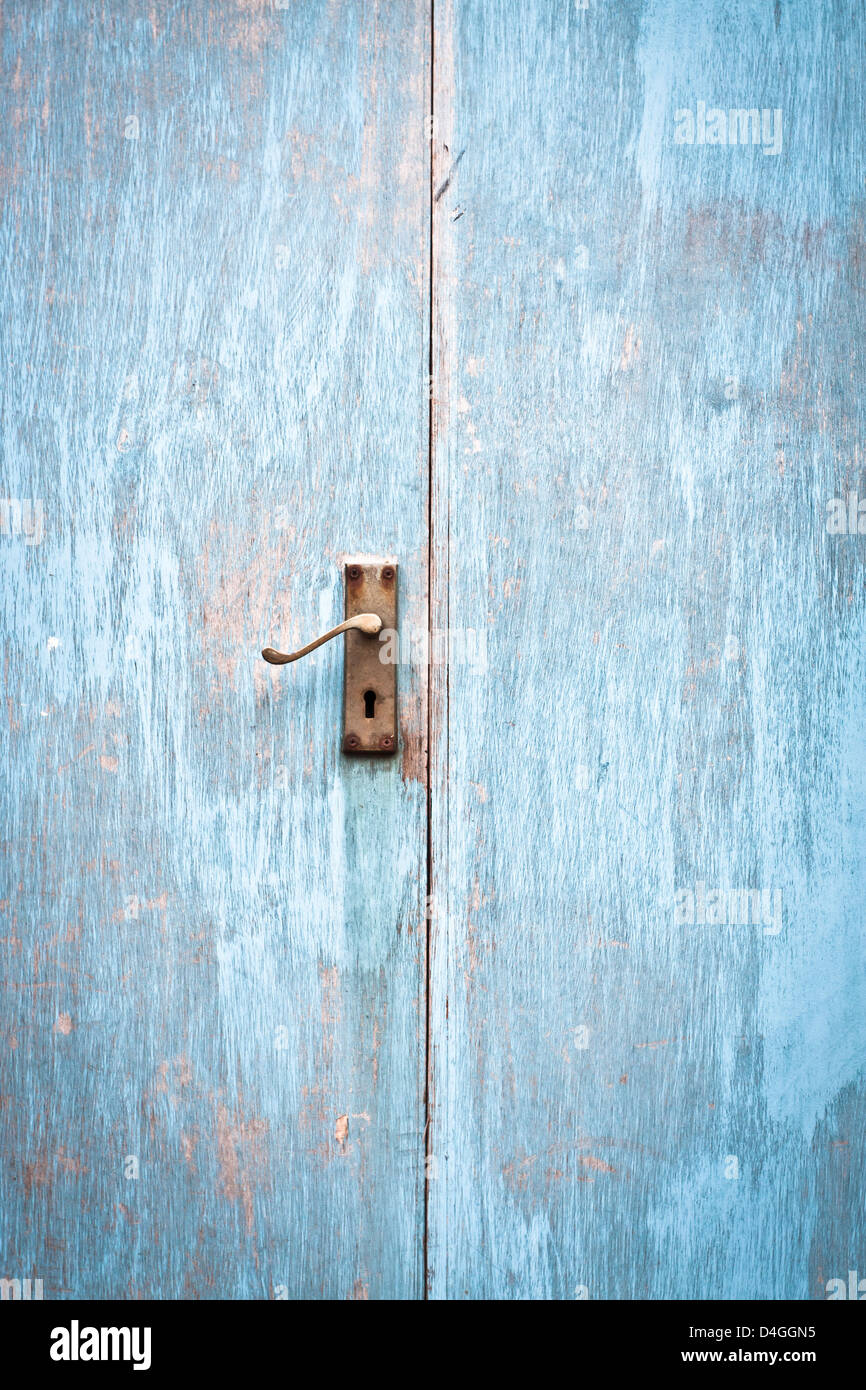 A weathered wooden blue door as a background image Stock Photo