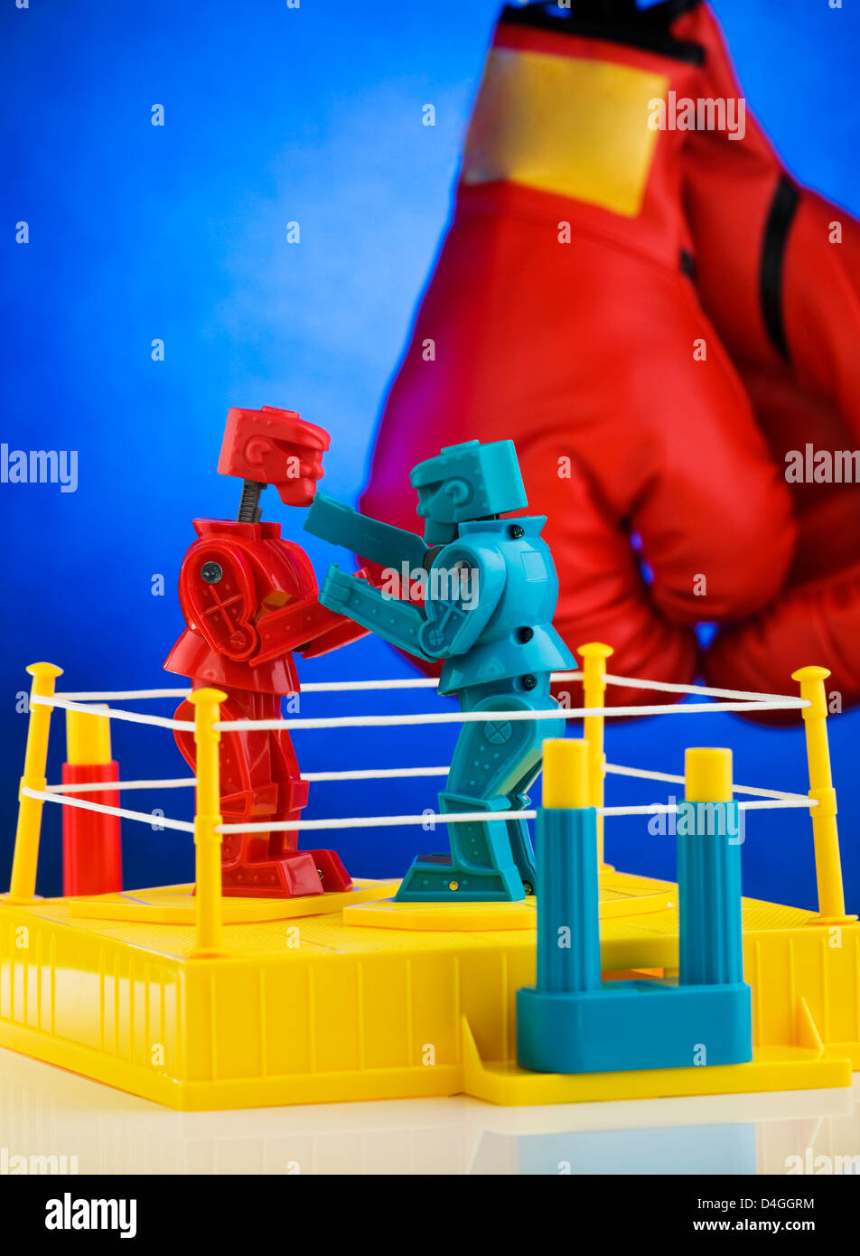 Rock 'em Sock 'em Robots a classic game by Mattel toys. With boxing gloves (removed logo) in background. Stock Photo