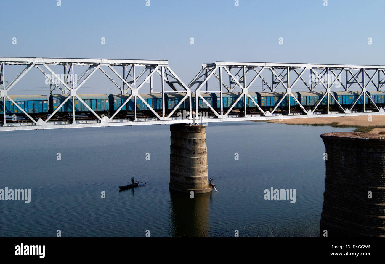 Steel Iron Bridge crossing the Krishna River and Passing by Goods Train at Vijayawada, Andhra Pradesh, India Stock Photo