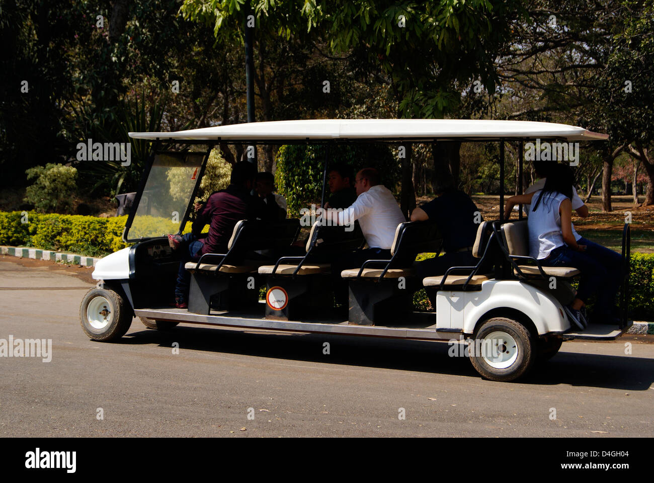 Battery Operated Eco Friendly Car Carrying Visitors Inside lalbagh Botanical garden at Bangalore City India Stock Photo