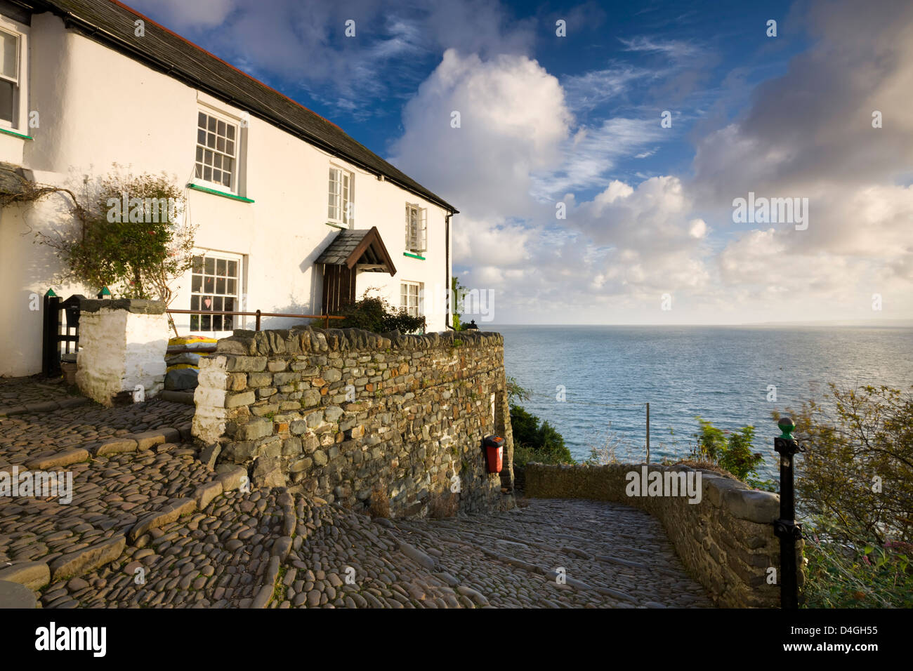 Whitewashed cottage and cobbled lane in the picturesque village of Clovelly, Devon, England. Autumn (September). Stock Photo