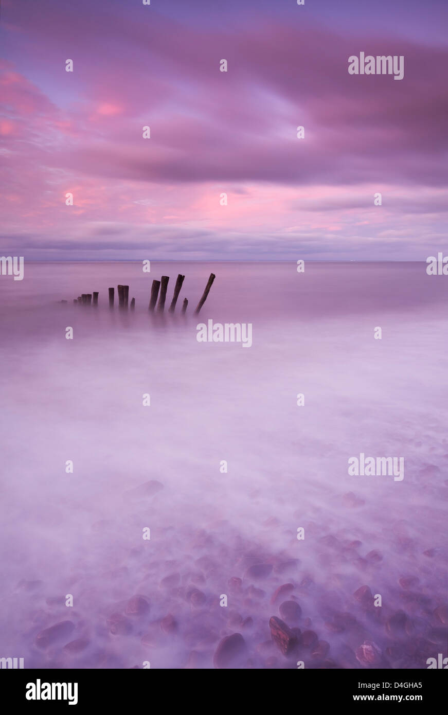 Wooden posts at high tide on Porlock Beach, Exmoor, Somerset. Stock Photo
