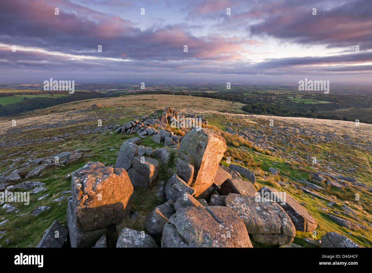 Early morning autumn sunlight lights up the granite rocks of Belstone Tor, Dartmoor, Devon. Stock Photo