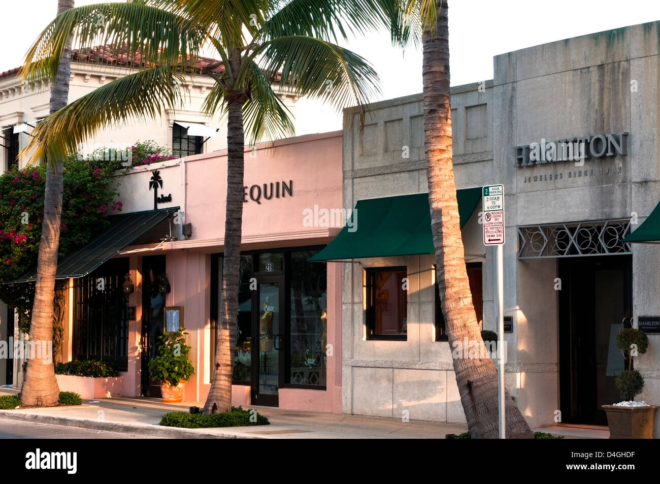 The palm tree lined street and storefronts of Worth Avenue, West Pam Beach Florida Stock Photo