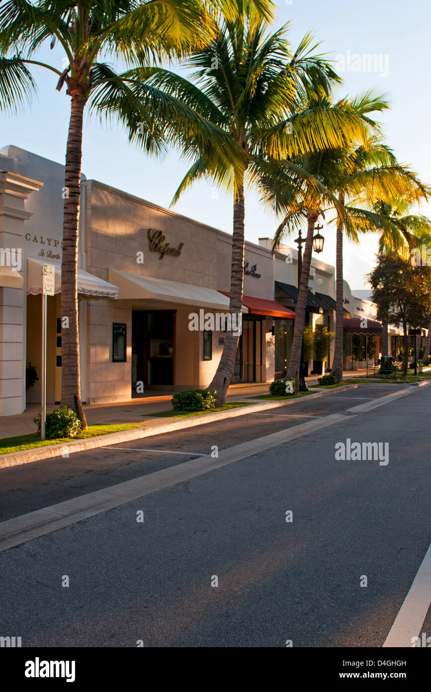 The palm tree lined street and storefronts of Worth Avenue, West Pam Beach Florida Stock Photo