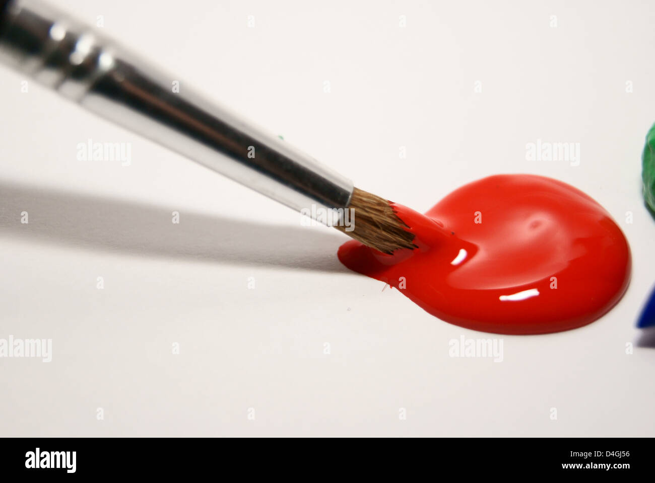 paintbrush in red paint Stock Photo - Alamy