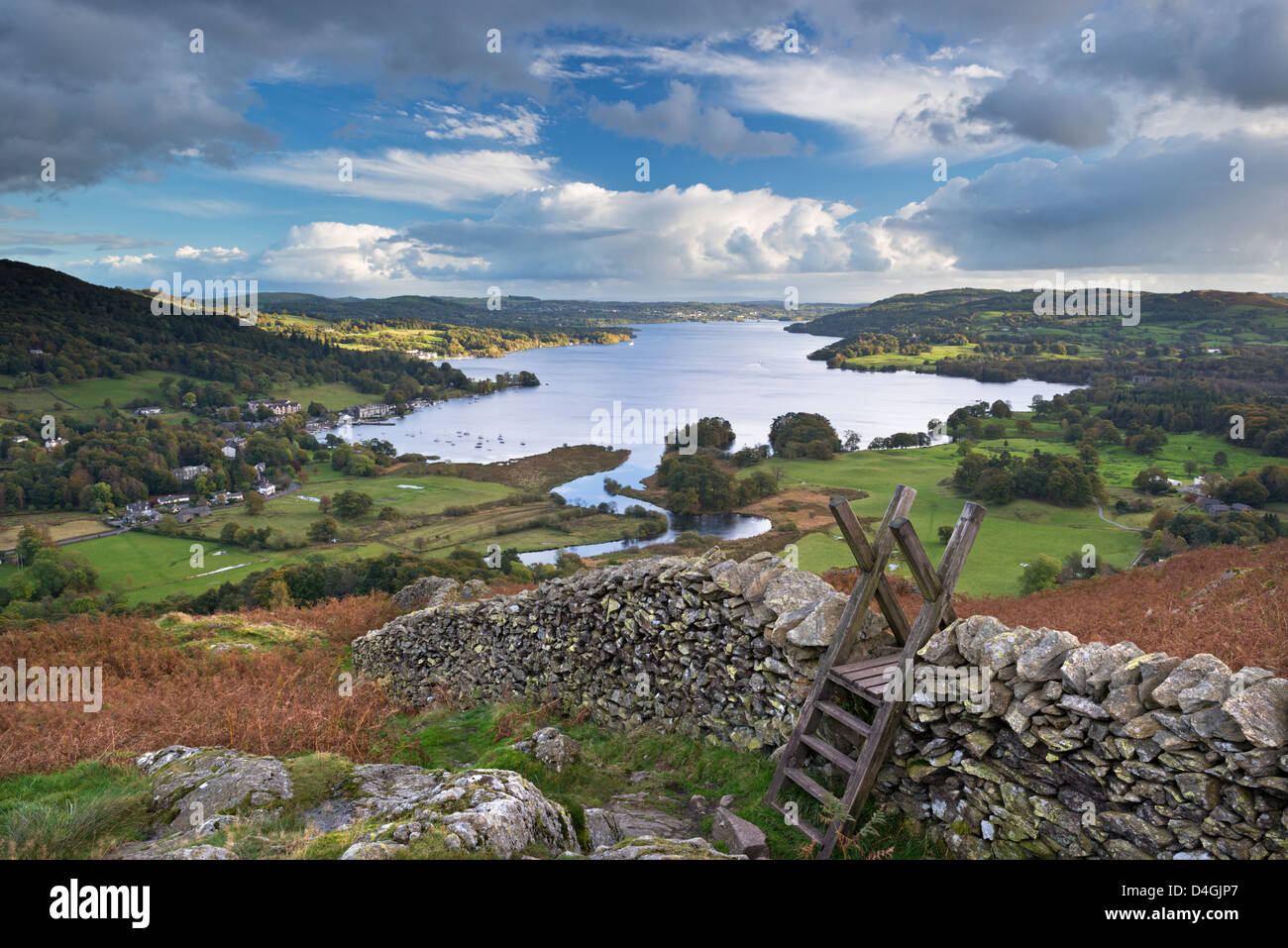 Footpath stile over dry stone wall, overlooking Lake Windermere, Lake District, Cumbria, England. Autumn (October) 2012 Stock Photo