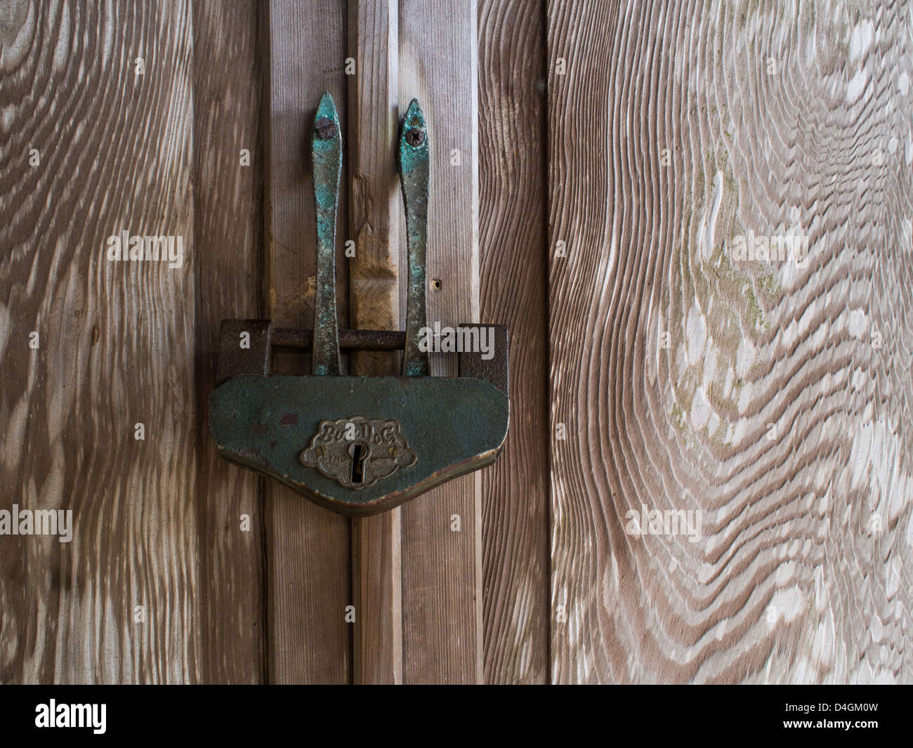 Traditional Japanese padlock  (Jomae) secures the wooden door of a Shinto shrine. Stock Photo
