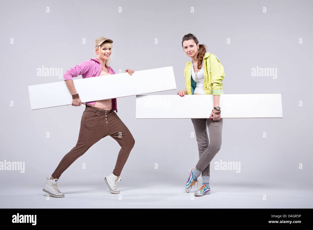 Relaxed fit girlfriends with empty boards Stock Photo