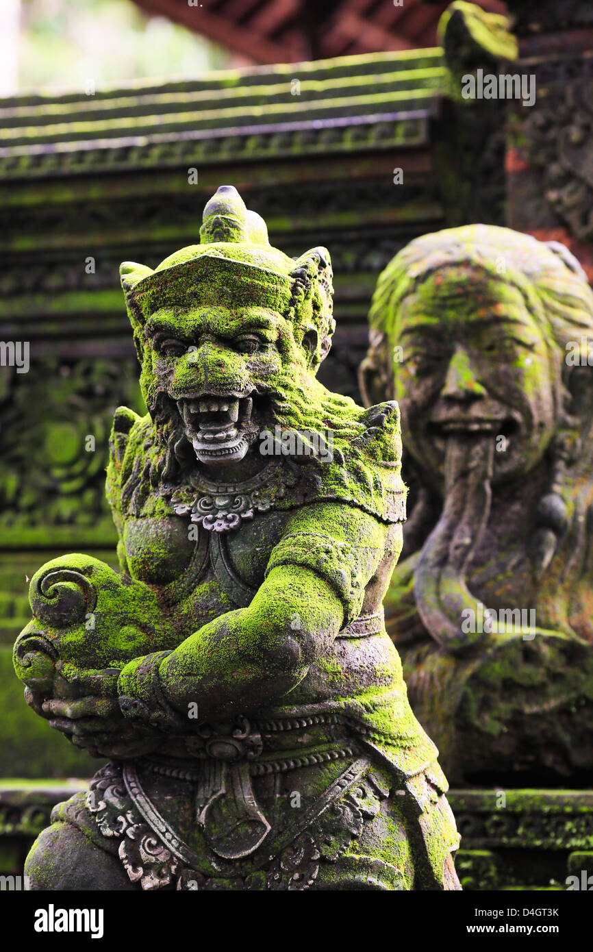 Stones monkey statues in front of Pura Dalem Agung Padangtegal temple