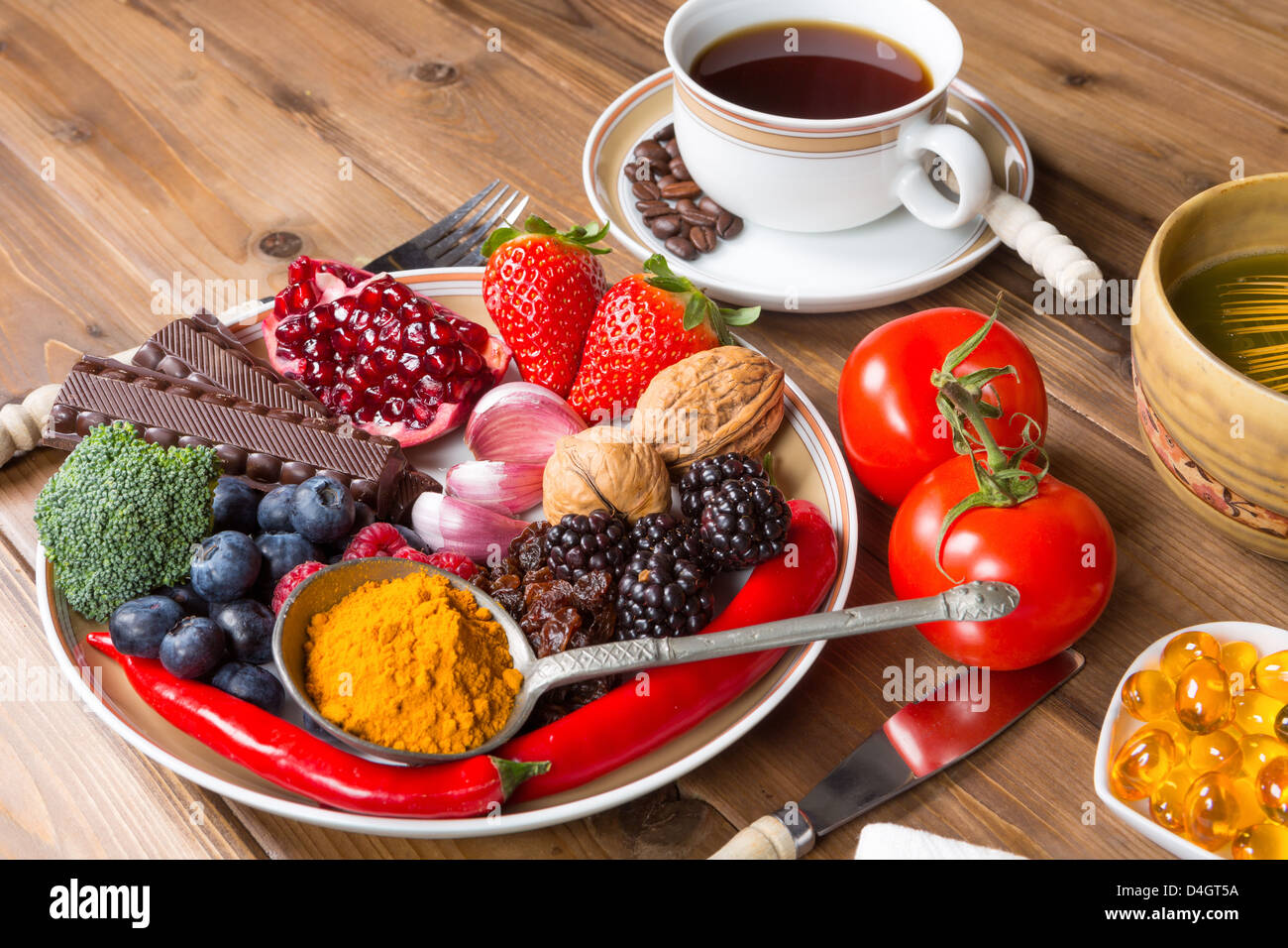 Wooden table filled with antioxidant drinks and food Stock Photo