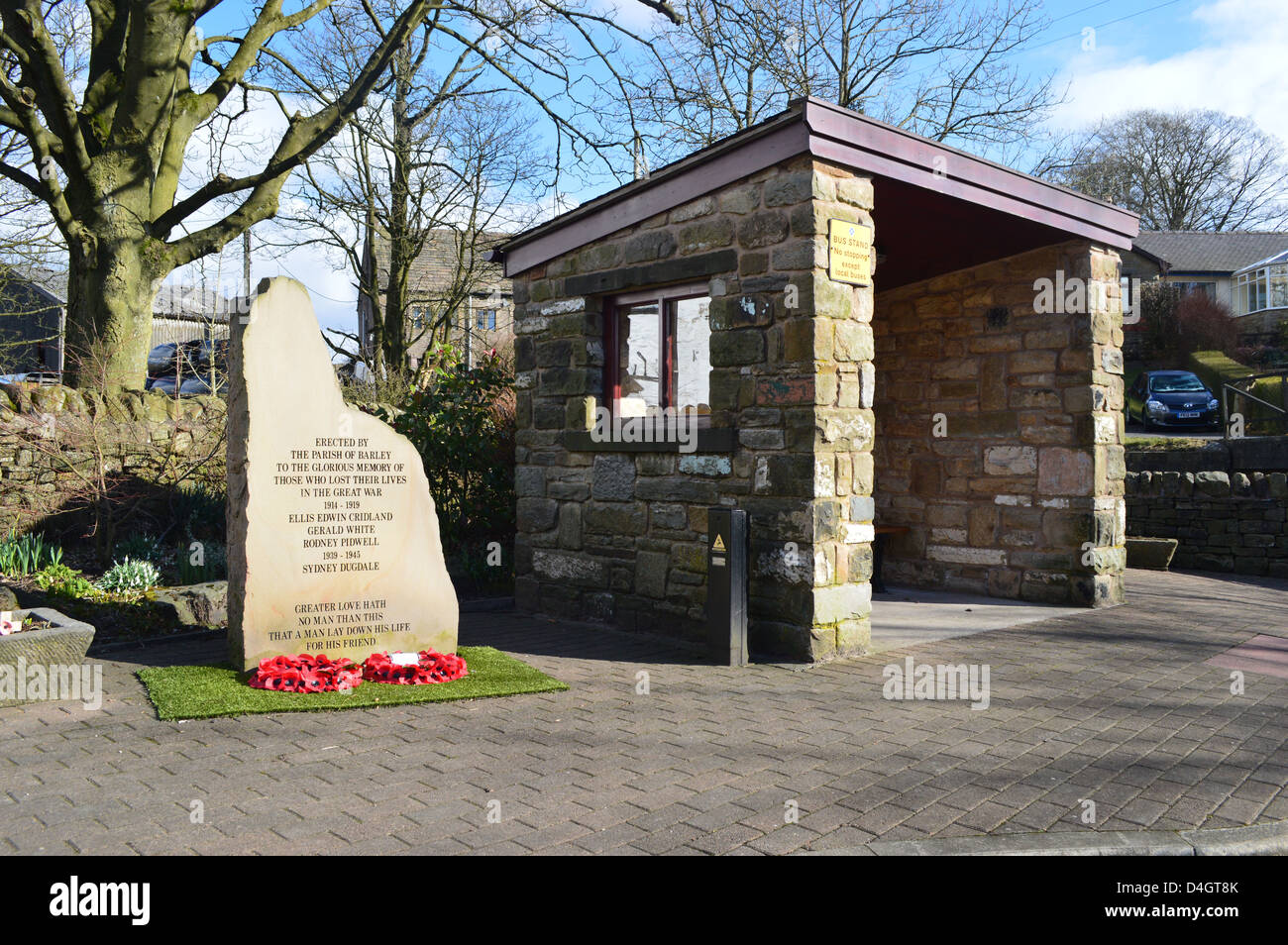 Small bus shelter and war memorial in winter sunshine in the village of Barley Lancashire Stock Photo
