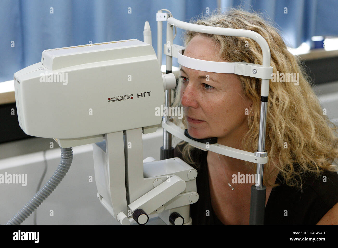 A woman is pictured during a computer analysis of the optic nerv within the scope of a glaucoma preventive examination at the university eye clinic in Erlangen, Germany, 26 June 2008. Glaucoma (also known as 'Green Star') is one of the major causes for loss of sight. Unnoticed by the patient the disease starts with the loss of the sensory cells of the optic nerv and the retina, whi Stock Photo