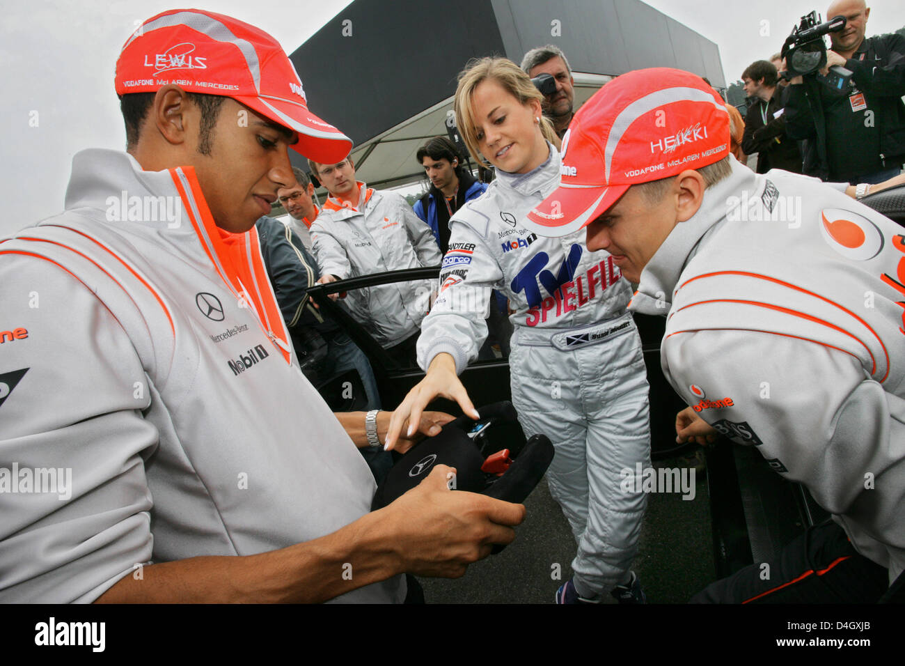 Scottish touring car driver Susie Stoddart (C) chats with British Formula One driver Lewis Hamilton of McLaren Mercedes (L) and teammate Heikki Kovalainen at Hockenheim race track in Germany, 17 July 2008. The German Grand Prix will take place on 20 July 2008. Photo: JENS BUETTNER Stock Photo